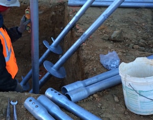 ECP helical piers being installed to raise new foundation slab