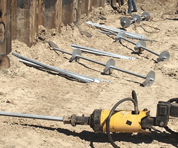Helical tiebacks laid out in preparation for a retaining wall job.